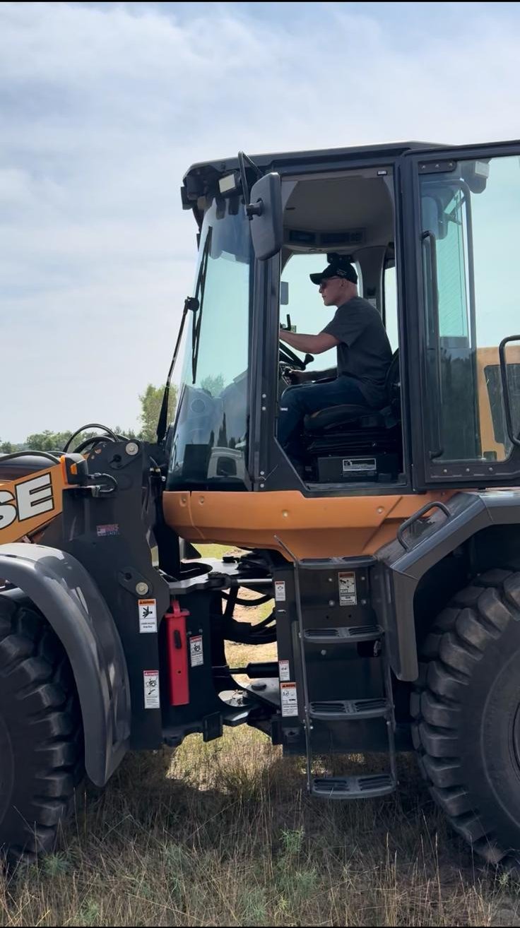 Operator running a CASE wheel loader at a field site